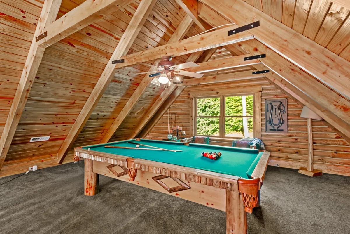 This interior shot captures the recreation zone with a pool table, wooden beams, and large windows. The space is designed for friendly competitions and socializing, echoing the section's reference to billiards, dart tournaments, and group games.